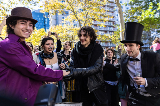FILE - Miles Mitchell, left and Zander Dueve, center, shake hands at the Timothee Chalamet lookalike contest in New York on Oct. 27, 2024. (AP Photo/Stefan Jeremiah, File)