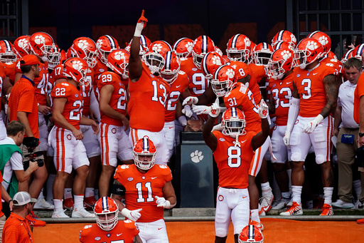 FILE - Clemson players touch Howard's Rock as they run onto the field for an NCAA college football game against Georgia Tech Saturday, Sept. 18, 2021, in Clemson, S.C. (AP Photo/John Bazemore, File)