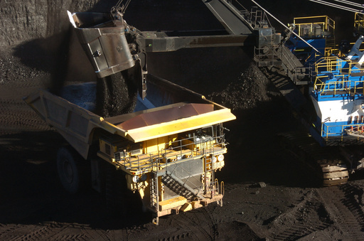 A mechanized shovel loads coal into a haul truck at the Spring Creek mine, in this Nov. 15, 2016 photo, near Decker, Mont. (AP Photo/Matthew Brown)
