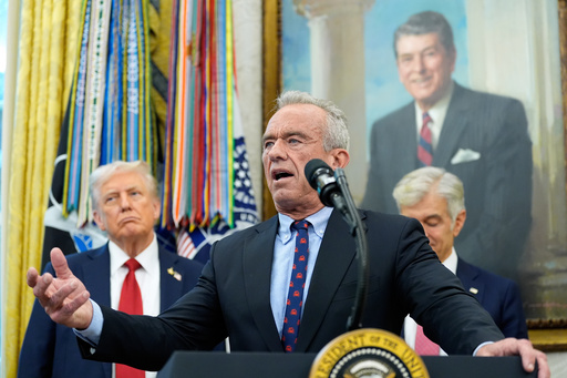 Secretary of Health and Human Services Robert F. Kennedy, Jr., speaks in the Oval Office of the White House, Tuesday, Sept. 30, 2025, in Washington, as President Donald Trump, left, and Mehmet Oz, Administrator for the Centers for Medicare & Medicaid Services, look on. (AP Photo/Alex Brandon)