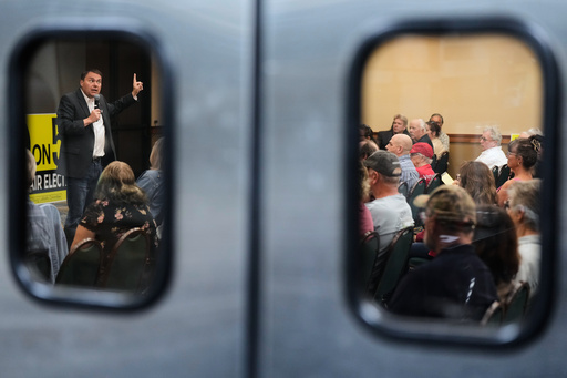 Republican Assemblymember Carl DeMaio, left, speaks to people attending a No on Prop 50 rally in Redding, Calif., Tuesday, Oct. 21, 2025. (AP Photo/Godofredo A. Vásquez)
