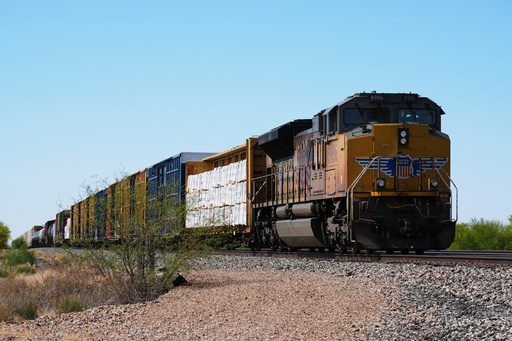 FILE - A Union Pacific freight train idles on the track as it waits to continue moving, Thursday, April 17, 2025, in Red Rock, Ariz. (AP Photo/Ross D. Franklin, File)