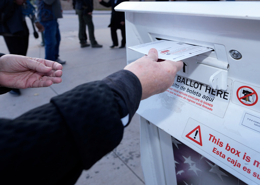 FILE - A voter places a ballot in a drop box outside the Denver Elections Division headquarters, Nov. 8, 2022, in downtown Denver. (AP Photo/David Zalubowski, File)