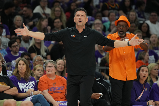 Phoenix Mercury head coach Nate Tibbetts reacts after a foul call against the Las Vegas Aces during the first half of Game 4 of the WNBA basketball finals, Friday, Oct. 10, 2025, in Phoenix. (AP Photo/Rick Scuteri)