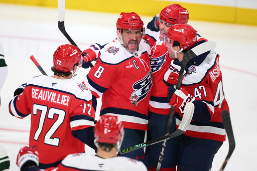 Washington Capitals left wing Alex Ovechkin (8) celebrates his goal with teammates during the third period of an NHL hockey game against the Minnesota Wild, Friday, Oct. 17, 2025, in Washington. (AP Photo/Nick Wass)
