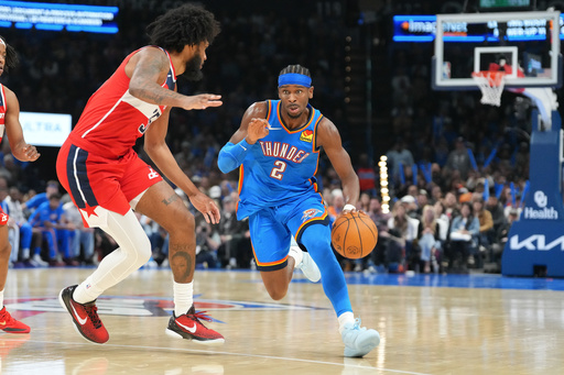 Oklahoma City Thunder guard Shai Gilgeous-Alexander, right, drives past Washington Warriors forward Marvin Bagley III, left, during the second half of an NBA basketball game, Thursday, Oct. 30, 2025, in Oklahoma City. (AP Photo/Kyle Phillips)