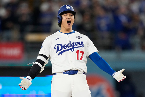 Los Angeles Dodgers' Shohei Ohtani celebrates hit RBI-Double against the Toronto Blue Jays during the fifth inning in Game 3 of baseball's World Series, Monday, Oct. 27, 2025, in Los Angeles. (AP Photo/Brynn Anderson)