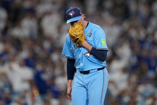 Toronto Blue Jays' pitcher Shane Bieber yells in his glove as he leaves the game during the sixth inning in Game 4 of baseball's World Series against the Los Angeles Dodgers, Tuesday, Oct. 28, 2025, in Los Angeles. (AP Photo/Ashley Landis)