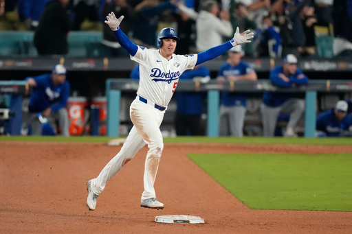 Los Angeles Dodgers' Freddie Freeman celebrates his walk off home run against the Toronto Blue Jays during the 18th inning in Game 3 of baseball's World Series, Monday, Oct. 27, 2025, in Los Angeles. (AP Photo/Mark J. Terrill)