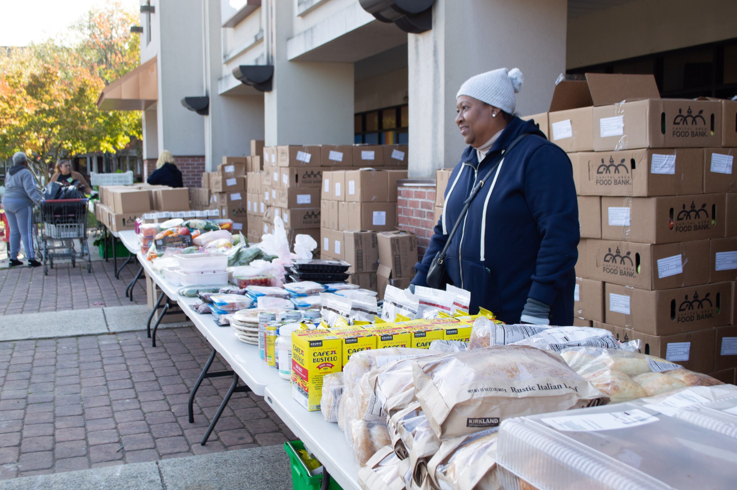Volunteers with the Capital Area Food Bank distribute items to furloughed federal workers in partnership with No Limits Outreach Ministries in Hyattsville, Maryland, on Tuesday, Oct. 28, 2025. (Photo by Ashley Murray/States Newsroom)