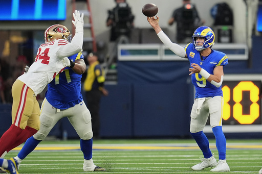 Los Angeles Rams quarterback Matthew Stafford (9) passes as San Francisco 49ers defensive end Yetur Gross-Matos, left, applies pressure during the first half of an NFL football game, Thursday, Oct. 2, 2025, in Inglewood, Calif. (AP Photo/Marcio Jose Sanchez)