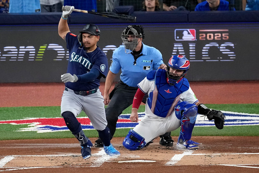 Seattle Mariners' Josh Naylor follows through on an RBI base hit off Toronto Blue Jays pitcher Shane Bieber (57) during the first inning in Game 7 of baseball's American League Championship Series, Monday, Oct. 20, 2025, in Toronto. (AP Photo/David J. Phillip)
