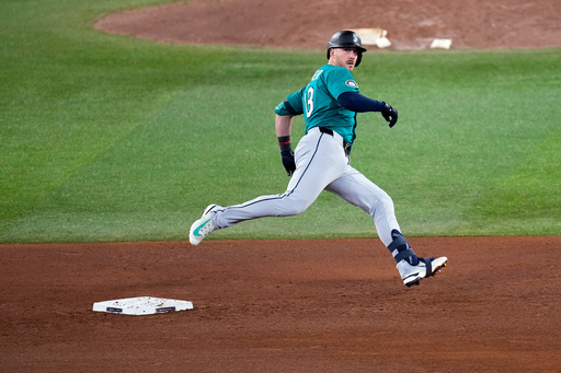 Seattle Mariners' Mitch Garver runs out a pinch hit triple against the Toronto Blue Jays during the sixth inning in Game 2 of baseball's American League Championship Series, Monday, Oct. 13, 2025, in Toronto. (AP Photo/David J. Phillip)