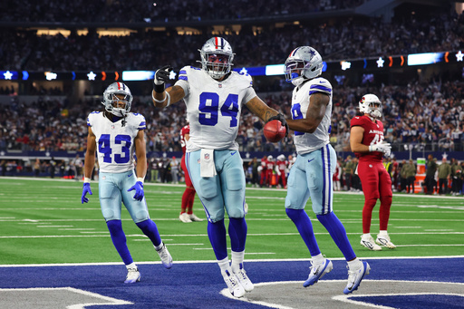 Dallas Cowboys defensive end Marshawn Kneeland (94), Malik Davis (43) and Damone Clark, right, celebrate after Kneeland recovered a blocked punt for a touchdown in the first half of an NFL football game against the Arizona Cardinals Monday, Nov. 3, 2025, in Arlington, Texas. (AP Photo/Richard Rodriguez)
