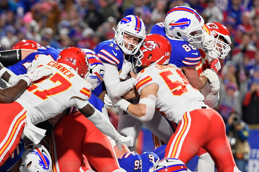 Buffalo Bills quarterback Josh Allen (17) scores as Kansas City Chiefs linebacker Leo Chenal (54) and defensive back Chamarri Conner, left, defend during the first half of an NFL football game Sunday, Nov. 2, 2025, in Orchard Park. N.Y. (AP Photo/Adrian Kraus)