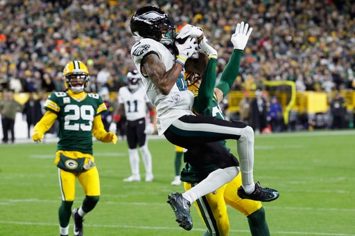 Philadelphia Eagles wide receiver DeVonta Smith (6) catches a pass for a touchdown against the Green Bay Packers during the second half of an NFL football game Monday, Nov. 10, 2025, in Green Bay, Wis. (AP Photo/Mike Roemer)