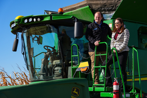 U.S. Secretary of Agriculture Brooke L. Rollins, right, films a social media post on a combine with farm owner Tyler Everett during a farm tour in Lebanon, Ind., Thursday, Oct. 30, 2025. (AP Photo/Michael Conroy)