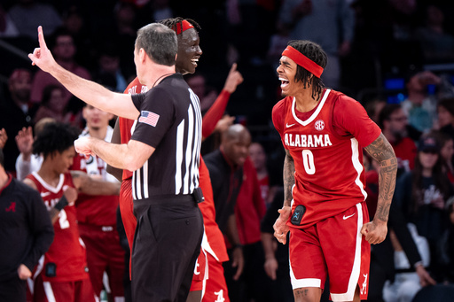 Alabama forward Taylor Bol Bowen (7) and guard Labaron Philon (0) celebrate a basket near the end of an NCAA college basketball game against St. John's, Saturday, Nov. 8, 2025, in New York. (AP Photo/Angelina Katsanis)