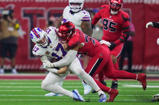 Buffalo Bills quarterback Josh Allen (17) is sacked by Houston Texans linebacker Henry To'oTo'o (39) in the second half of an NFL football game Thursday, Nov. 20, 2025, in Houston. (AP Photo/Ashley Landis)