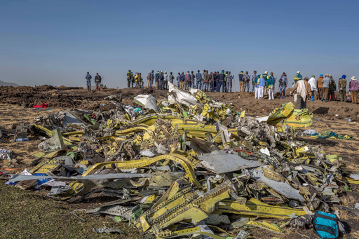 FILE - Wreckage is piled at the crash scene of Ethiopian Airlines flight ET302 near Bishoftu, Ethiopia, March 11, 2019. (AP Photo/Mulugeta Ayene, File)