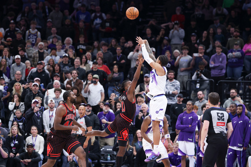 Utah Jazz guard Keyonte George (3) makes a three-point basket over Chicago Bulls guard Ayo Dosunmu to take the lead in the last seconds of the second overtime of an NBA basketball game, Sunday, Nov. 16, 2025, in Salt Lake City. (AP Photo/Rob Gray)