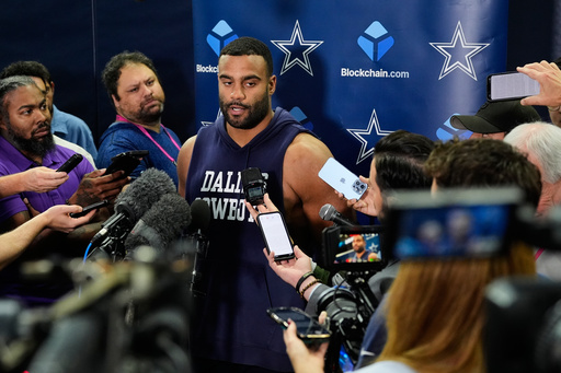 CORRECTS TO THURSDAY, NOV. 13 NOT FRIDAY, NOV. 14 - Dallas Cowboys' Solomon Thomas, center, responds to a question during a news conference after an NFL football practice at the team's headquarters Thursday, Nov. 13, 2025, in Frisco, Texas. (AP Photo/Tony Gutierrez)