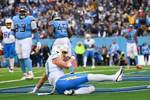 Los Angeles Chargers quarterback Justin Herbert (10) slides into the end zone to score a touchdown during the second half of an NFL football game against the Tennessee Titans Sunday, Nov. 2, 2025, in Nashville, Tenn. (AP Photo/John Amis)