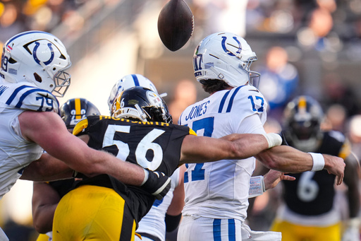 Pittsburgh Steelers linebacker Alex Highsmith (56) forces a fumble by Indianapolis Colts quarterback Daniel Jones (17) during the second half of an NFL football game in Pittsburgh, Sunday, Nov. 2, 2025. (AP Photo/Gene J. Puskar)