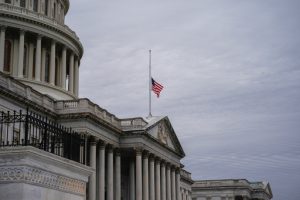 The American flag flies half-staff outside the U.S. Capitol, Tuesday, Nov. 18, 2025, in Washington. (AP Photo/Julia Demaree Nikhinson)