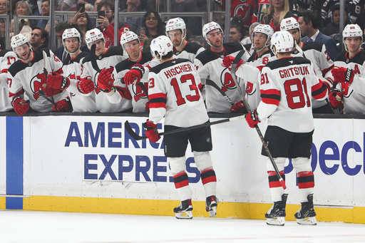 New Jersey Devils center Nico Hischier (13) and right wing Arseny Gritsyuk (81) celebrate after Hischier scored a goal during the first period of an NHL hockey game against the Los Angeles Kings, Saturday, Nov. 1, 2025, in Los Angeles. (AP Photo/Jessie Alcheh)