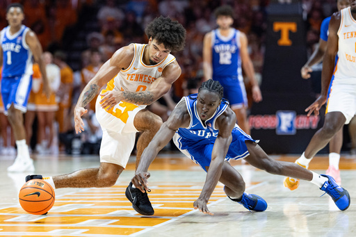 Duke guard Dame Sarr, right, battles for the ball with Tennessee guard Ja'Kobi Gillespie (0) during the second half of an NCAA college basketball exhibition game Sunday, Oct. 26, 2025, in Knoxville, Tenn. (AP Photo/Wade Payne)