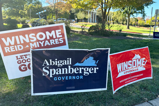 Campaign signs for Virginia gubernatorial nominees Democrat Abigail Spanberger and Republican Winsome Earle-Sears are on display outside City Hall in Fairfax, Va., Friday, Oct. 17, 2025. (AP Photo/Robert Yoon)