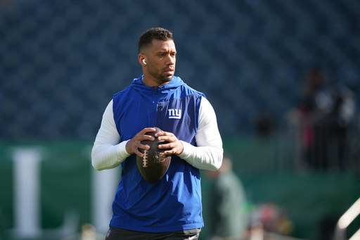 FILE - New York Giants' Russell Wilson warms up before an NFL football game against the Philadelphia Eagles, Oct. 26, 2025, in Philadelphia. (AP Photo/Matt Slocum, File)