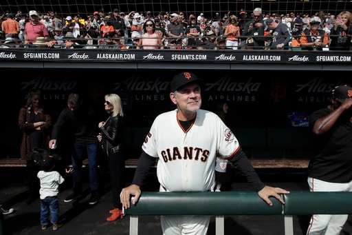 FILE - San Francisco Giants manager Bruce Bochy stands in the dugout before a baseball game between the Giants and the Los Angeles Dodgers in San Francisco, Sept. 29, 2019. (AP Photo/Jeff Chiu, File)