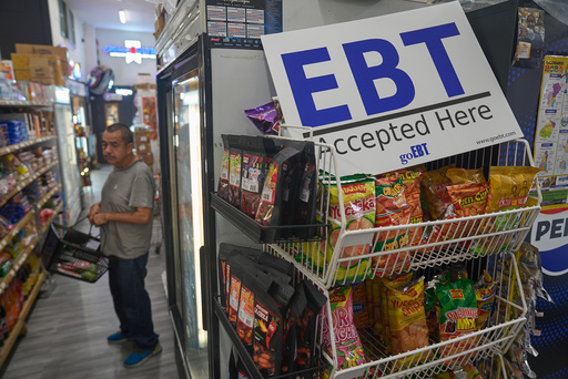 FILE - A banner reads: "EBT (Electronic Benefit Transfer) Accepted Here," at El Recuerdo Market in Los Angeles, Oct. 31, 2025, after two federal judges ordered President Donald Trump's administration to continue funding SNAP during the government shutdown. (AP Photo/Damian Dovarganes, file)