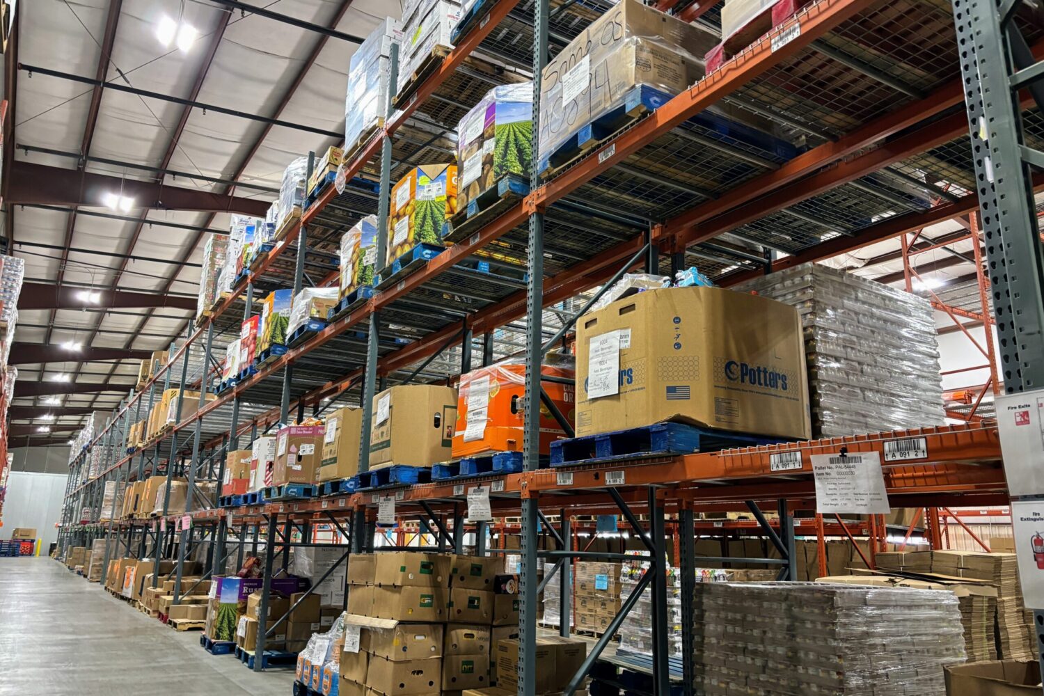 Shelves are stacked with boxes of food on Nov. 3, 2025, at Feeding South Dakota's Rapid City distribution center. (Seth Tupper/South Dakota Searchlight)