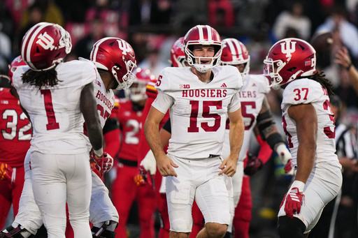 Indiana quarterback Fernando Mendoza (15) reacts after running back Roman Hemby scored a touchdown during the second half of an NCAA college football game against Maryland, Saturday, Nov. 1, 2025, in College Park, Md. (AP Photo/Stephanie Scarbrough)