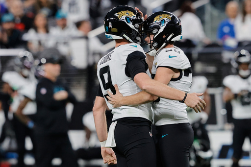 Jacksonville Jaguars place kicker Cam Little, right, celebrates with punter Logan Cooke after making a game-tying field goal during the second half of an NFL football game against the Las Vegas Raiders, Sunday, Nov. 2, 2025, in Las Vegas. (AP Photo/Steve Marcus)