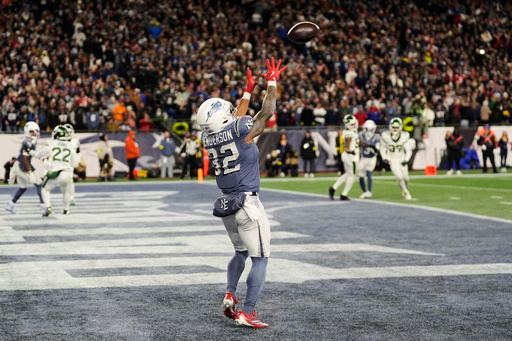 New England Patriots running back TreVeyon Henderson catches a touchdown pass during the second half of an NFL football game against the New York Jets, Thursday, Nov. 13, 2025, in Foxborough, Mass. (AP Photo/Charles Krupa)