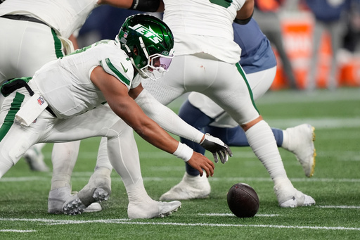 New York Jets quarterback Justin Fields fumbles the ball during the second half of an NFL football game against the New England Patriots, Thursday, Nov. 13, 2025, in Foxborough, Mass. (AP Photo/Robert F. Bukaty)