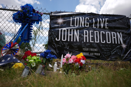 FILE - Candles, flowers, and notes are placed at a makeshift memorial in San Antonio, on Thursday, June 5, 2025, for voice actor Jonathan Joss who was recently killed. (AP Photo/Eric Gay, file)