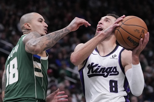 Milwaukee Bucks' Kyle Kuzma fouls Sacramento Kings' Zach LaVine during the first half of an NBA basketball game Saturday, Nov. 1, 2025, in Milwaukee. (AP Photo/Morry Gash)