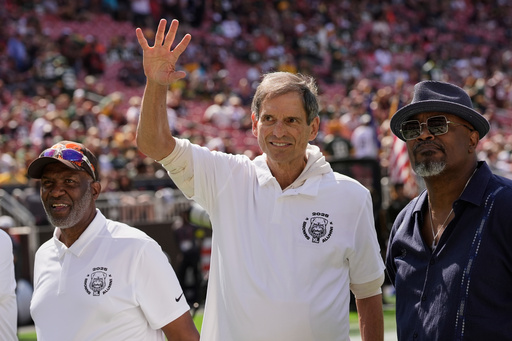 FILE - Former Cleveland Browns quarterback Bernie Kosar waves during a Browns' Alumni event before an NFL football game between the Green Bay Packers and the Cleveland Browns in Cleveland, Sunday, Sept. 21, 2025. (AP Photo/Sue Ogrocki, File)