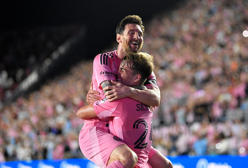 Inter Miami forward Lionel Messi, top, celebrates with forward Mateo Silvetti, bottom, after scoring during the first half of Game 3 in the first round of MLS soccer's Western Conference playoffs against Nashville SC in Fort Lauderdale, Fla., Nov. 8, 2025. (AP Photo/Michael Laughlin)