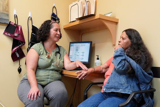Dr. Melissa Buddensee, left, meets with patient Susan Bushby at Ammonoosuc Community Health Services, Tuesday, Oct. 21, 2025, in Franconia, N.H., in the final days before the clinic closes for good. (AP Photo/Robert F. Bukaty)