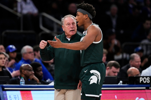 Michigan State head coach Tom Izzo, left, talks to Jeremy Fears Jr., right, during the first half of an NCAA college basketball game against Kentucky Tuesday, Nov. 18, 2025, in New York. (AP Photo/Frank Franklin II)