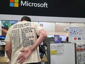 FILE - Middle school teacher Jeremy Hook shops for the latests Microsoft's Surface Laptop Copilot+ PC's at Best Buy Atwater Village store in Glendale, Calif., Tuesday, July 29, 2025. (AP Photo/Damian Dovarganes, File)