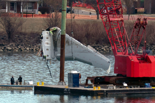 FILE - Rescue and salvage crews pull up airplane wreckage of an American Airlines jet in the Potomac River from Ronald Reagan Washington National Airport, Feb. 3, 2025, in Arlington, Va. (AP Photo/Jose Luis Magana, File)