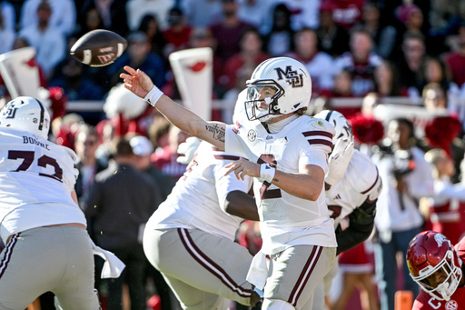 Mississippi State quarterback Blake Shapen (2) throws a pass under pressure from Arkansas during the first half of an NCAA college football game Saturday, Nov. 1, 2025, in Fayetteville, Ark. (AP Photo/Michael Woods)