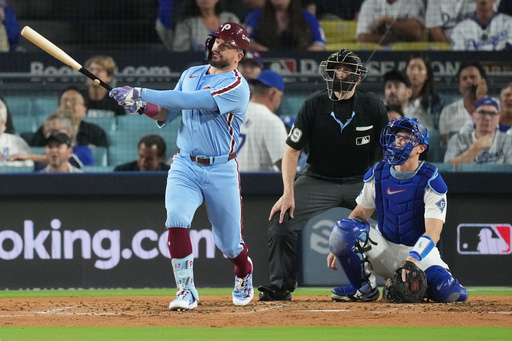 Philadelphia Phillies' Kyle Schwarber follows his solo home run off Los Angeles Dodgers starting pitcher Yoshinobu Yamamoto during the fourth inning in Game 3 of baseball's National League Division Series Wednesday, Oct. 8, 2025, in Los Angeles. (AP Photo/Jae C. Hong)